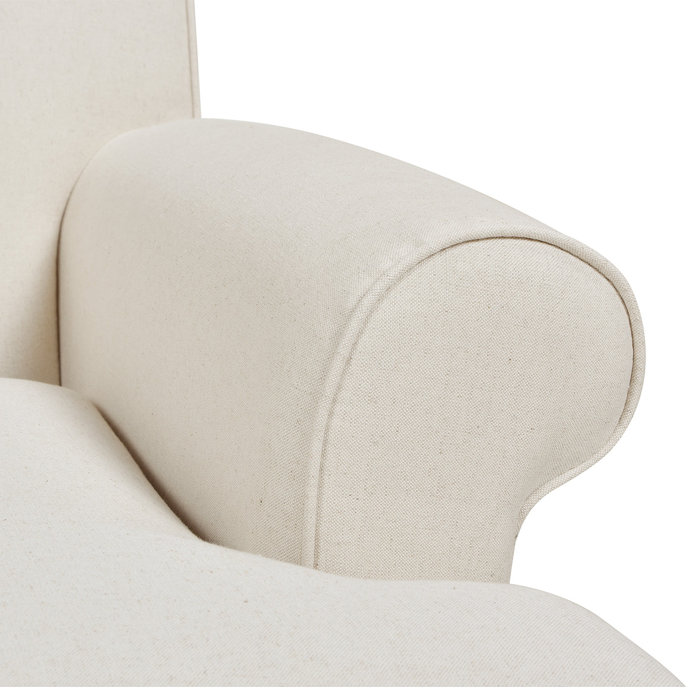 Closeup of upholstered armrest on a beige armchair showcasing textured linen fabric
