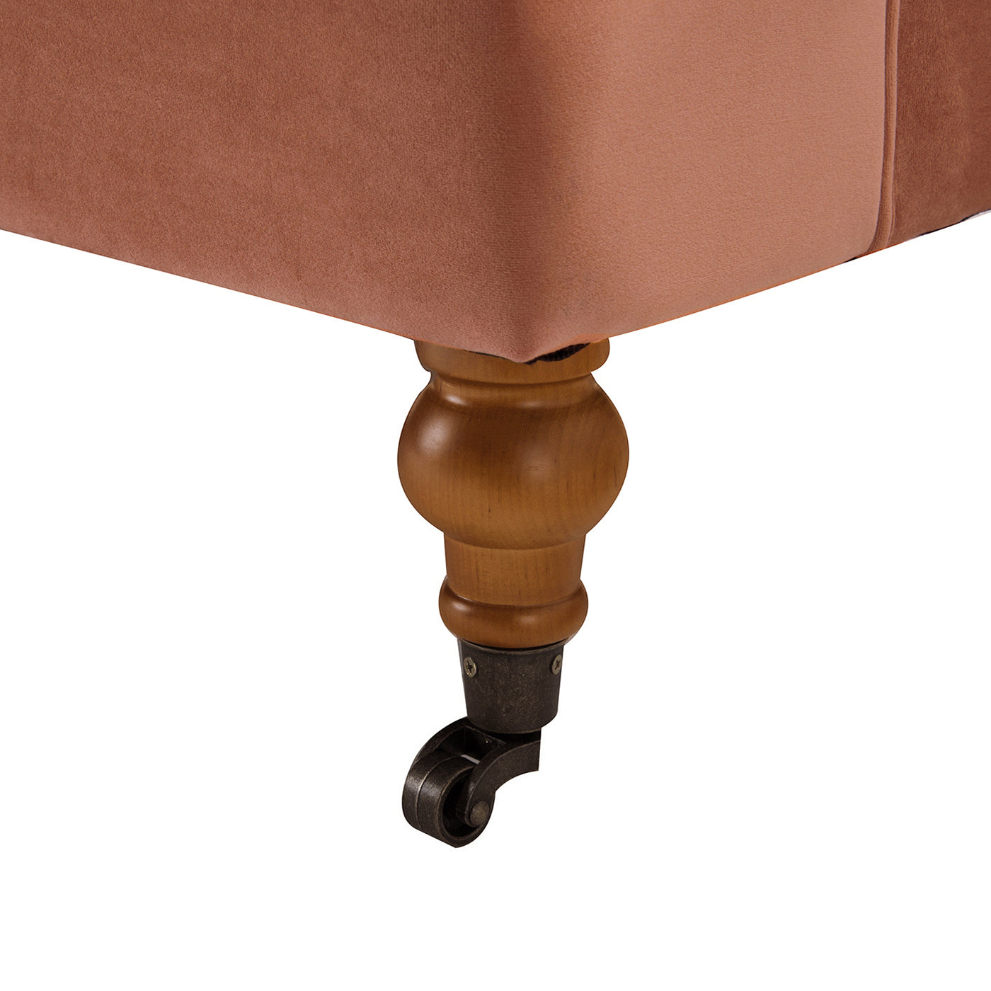 Rose velvet upholstered furniture leg with a wooden spindle and antique brass castor wheel