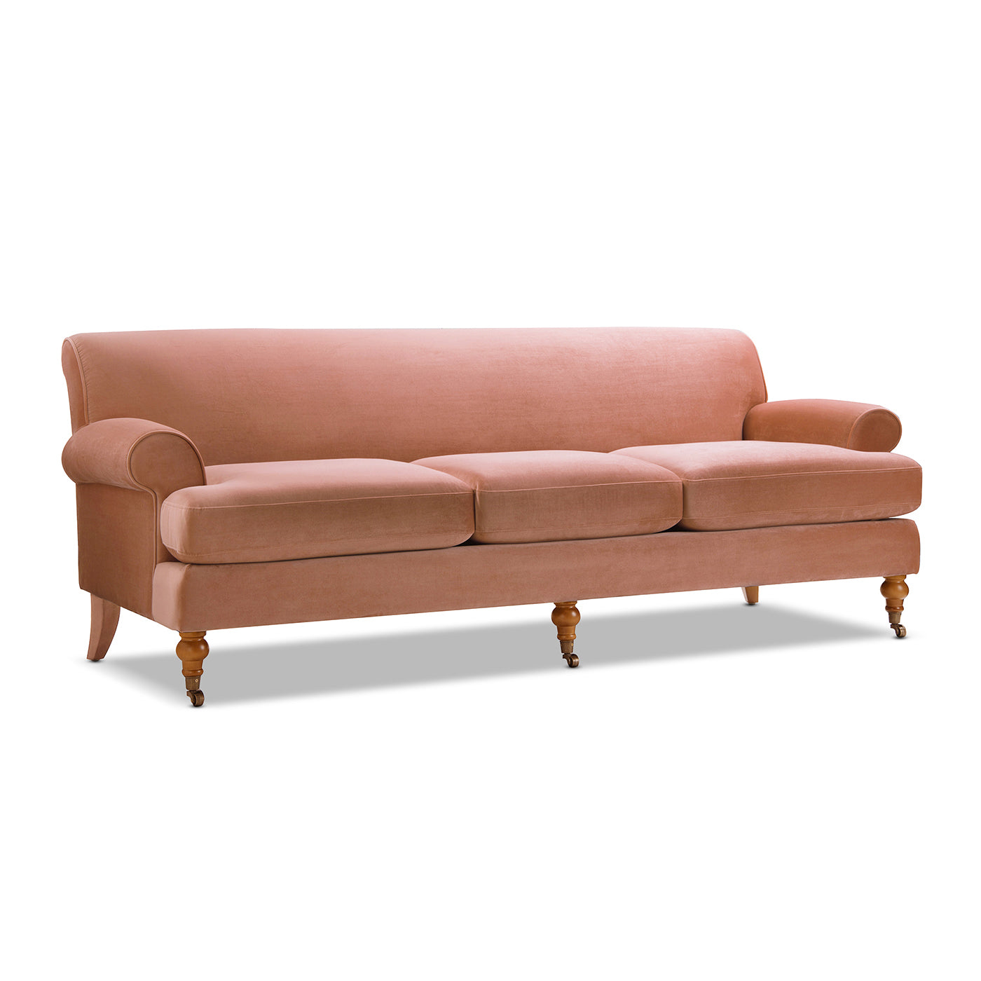 Dusty rose velvet sofa with rolled arms and cabriole legs on casters perfect for living rooms