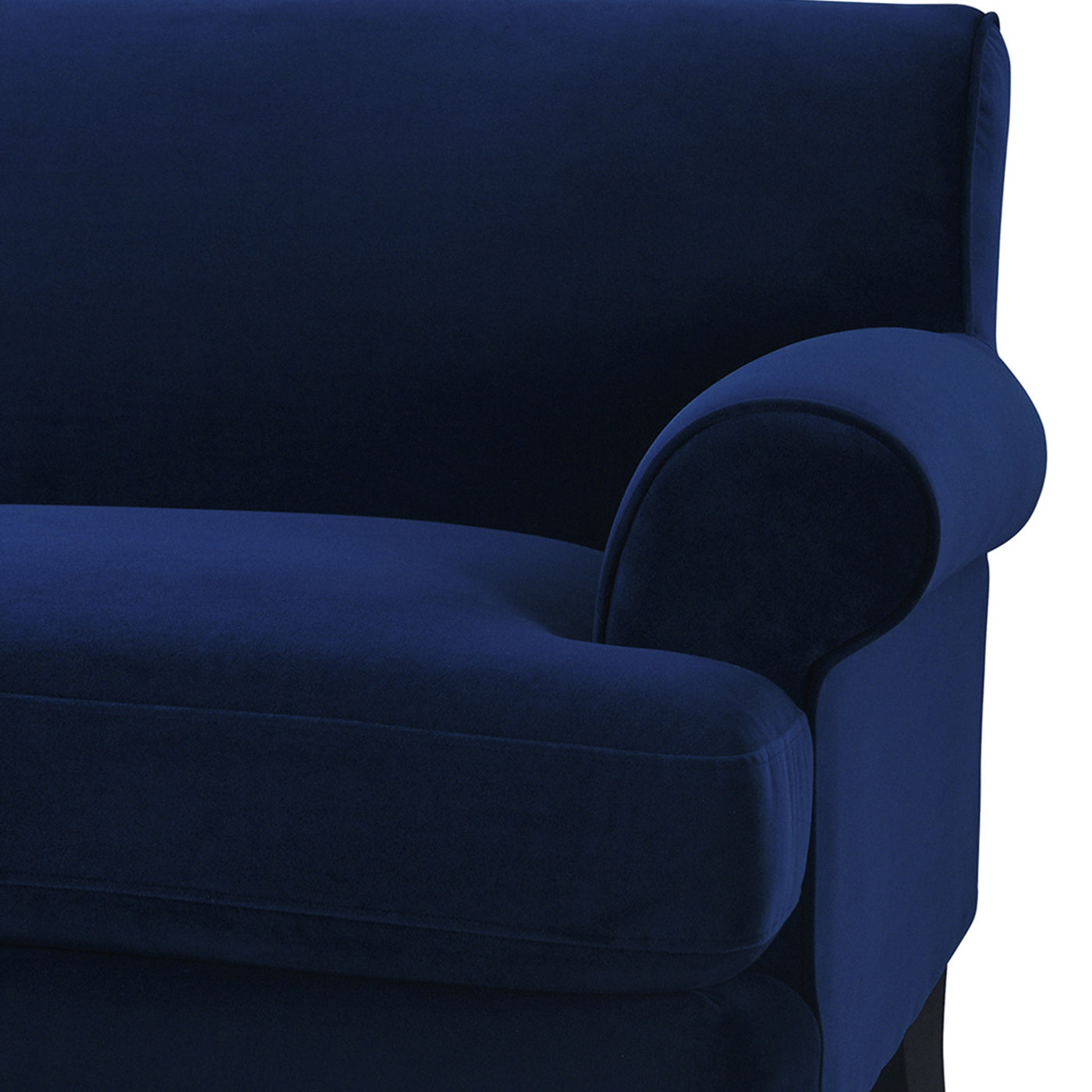 Deep navy velvet sofa with plush cushioning and a rolled armrest