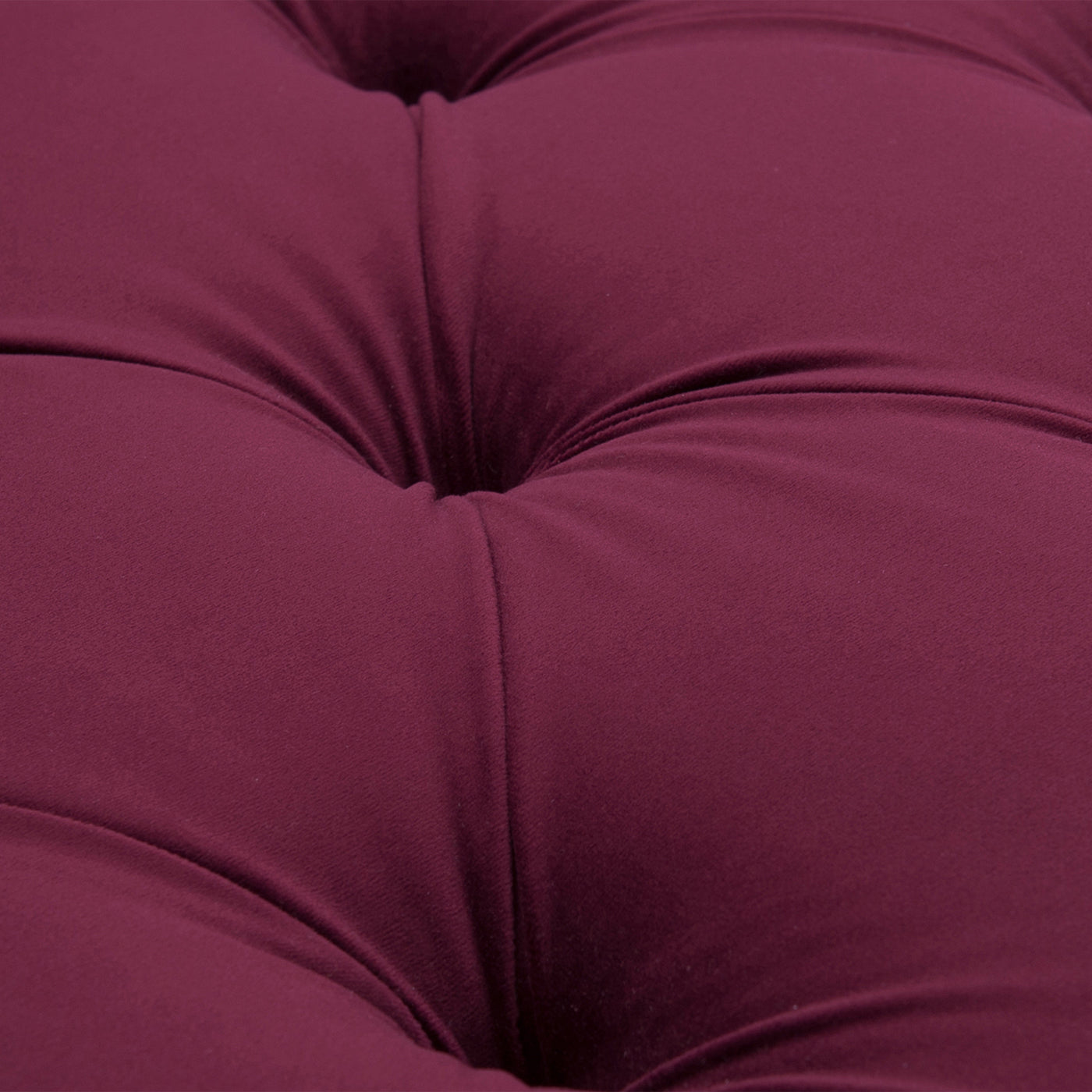 Deep plum tufted fabric closeup showing velvet texture
