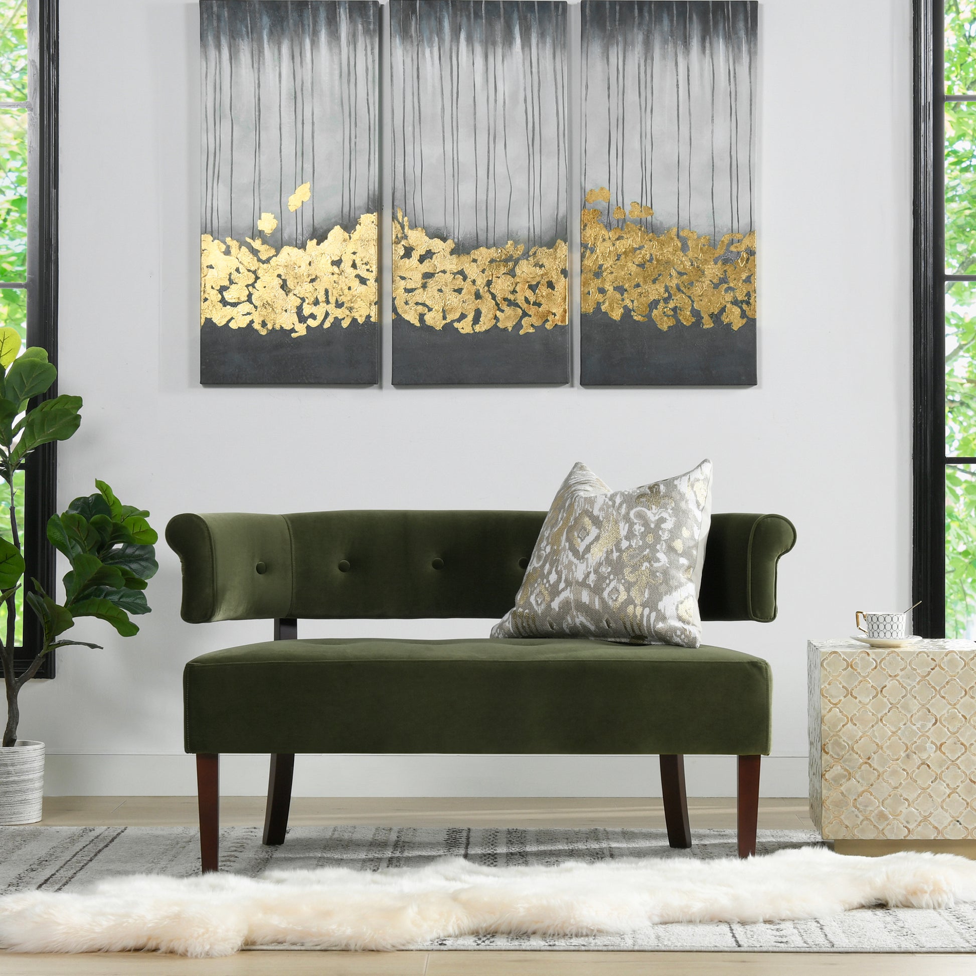 Luxurious olive green velvet bench with tufted back and gold leaf wall art