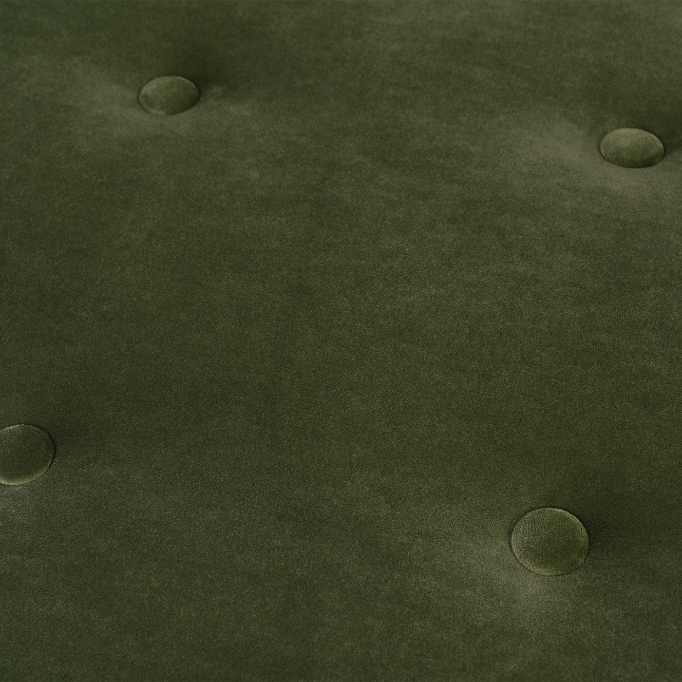 Deep green velvet tufted fabric texture with circular buttons