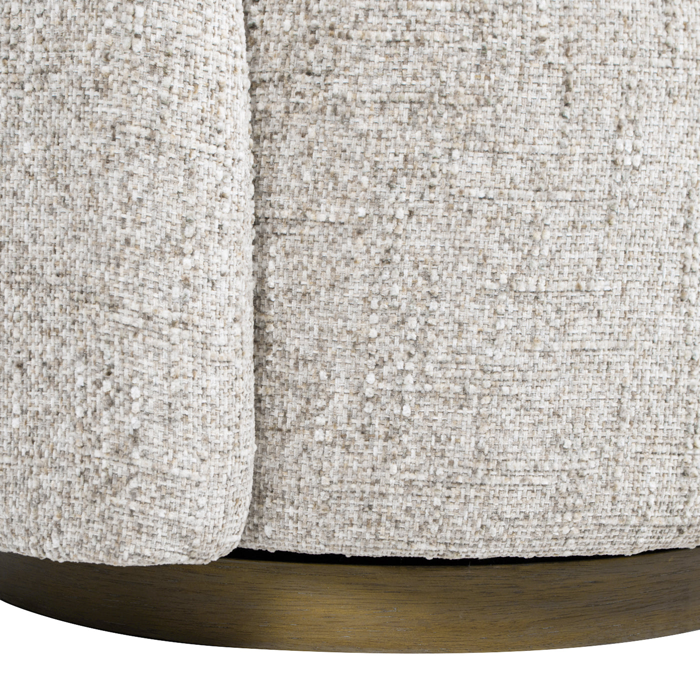 Textured oatmeal boucle fabric on a round accent ottoman with a brass base