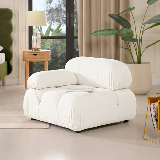 Plush white boucle armchair with rounded edges and comfortable seating for a cozy living room