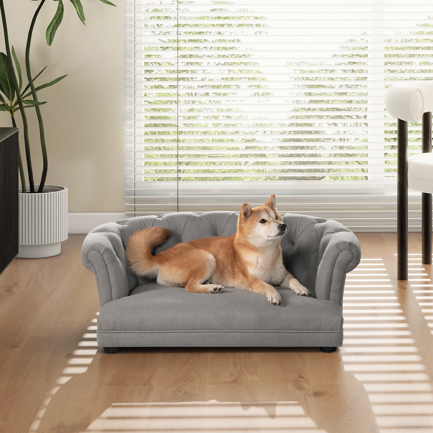 Grey tufted dog sofa with elegant rolled arms for cozy pet relaxation
