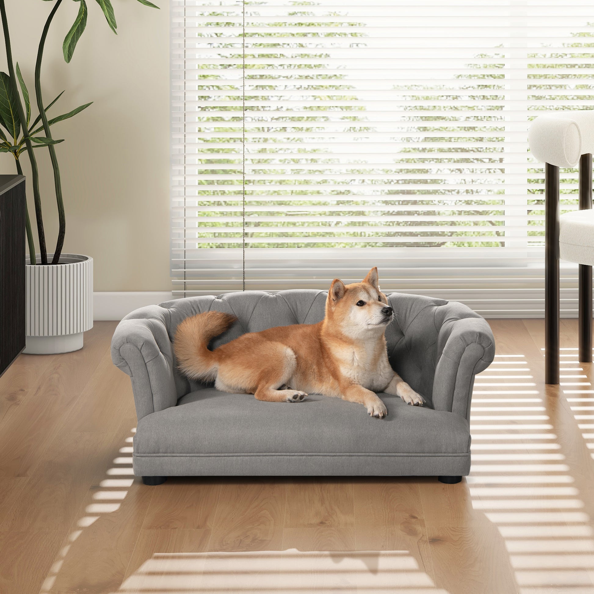Grey tufted dog sofa with elegant rolled arms for cozy pet relaxation