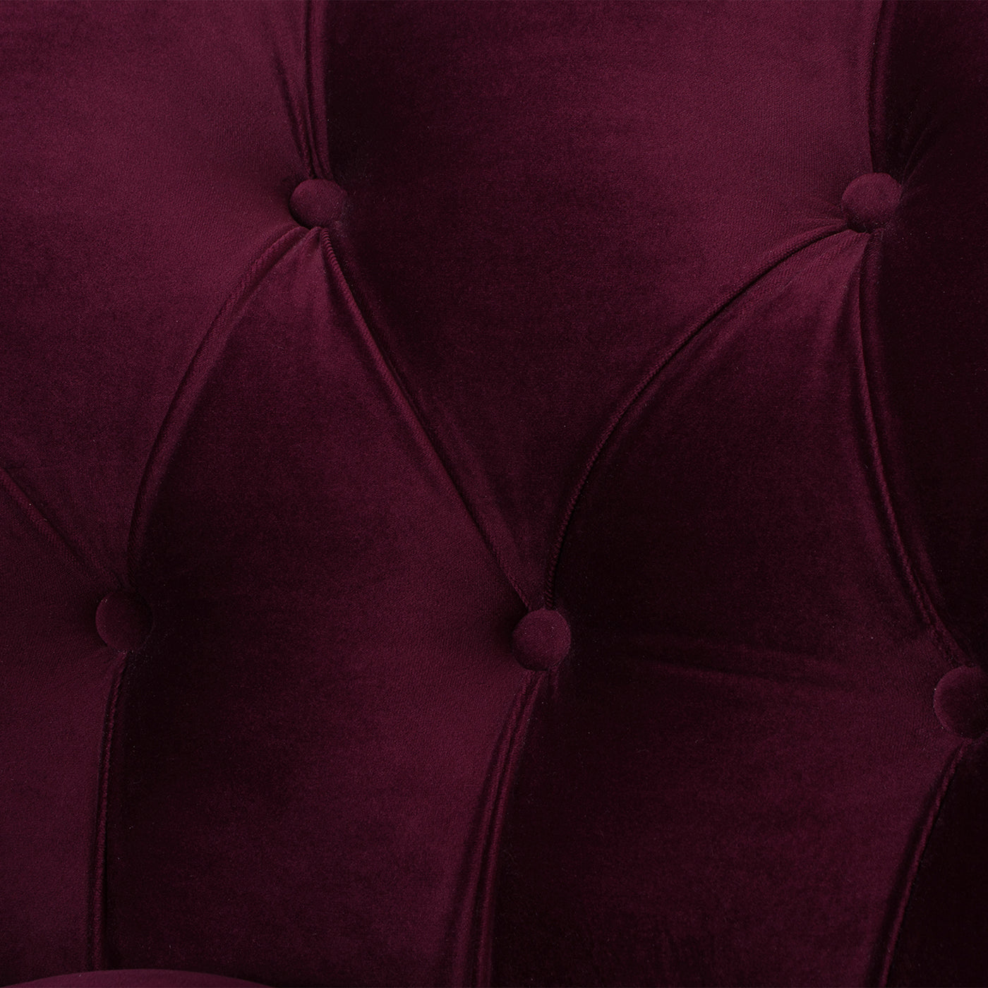 Deep burgundy velvet upholstery with classic tufted diamond pattern for a luxurious sofa