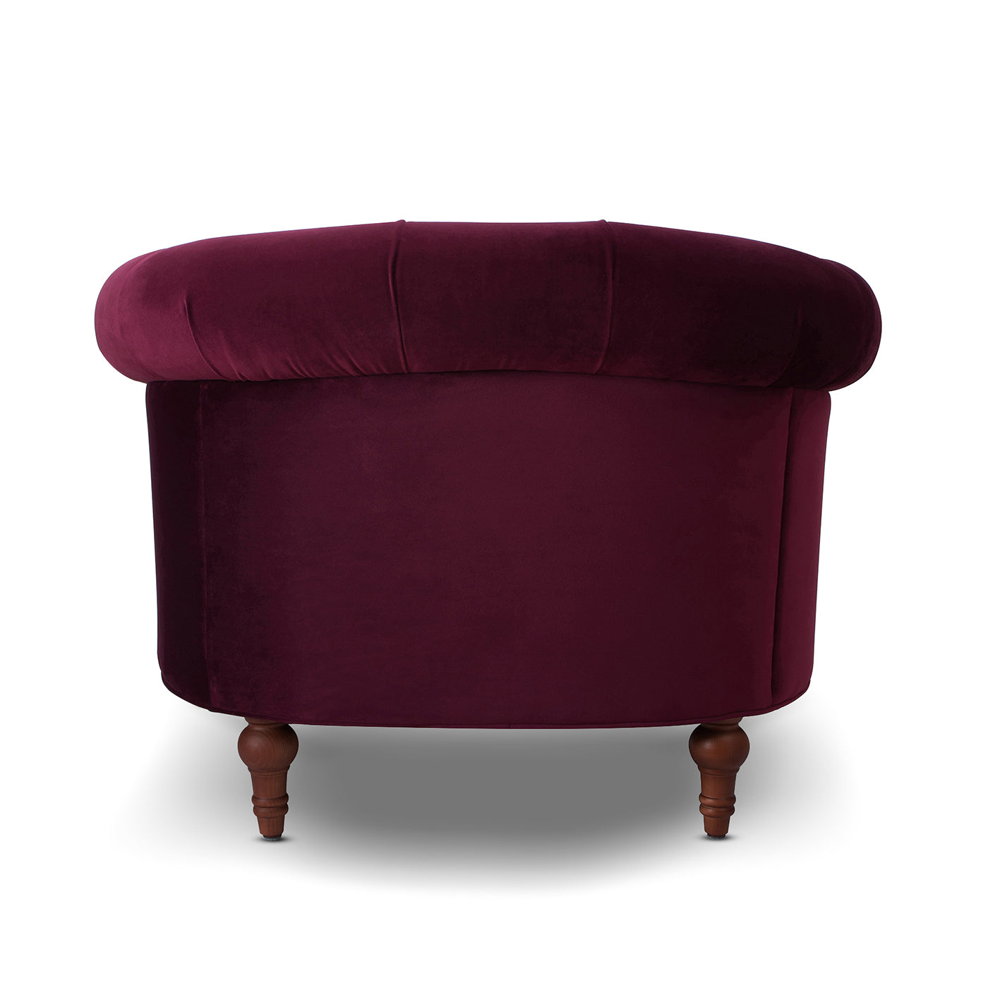 Plush eggplant velvet accent chair with tufted back and turned wooden legs