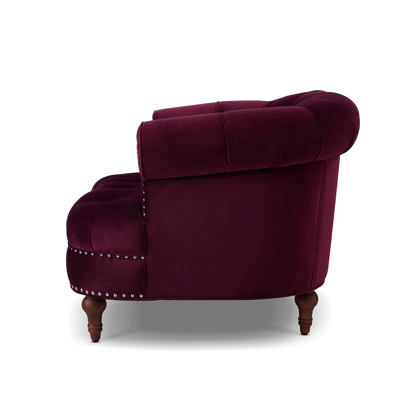 Plush burgundy velvet armchair with classic button tufting and silver nailhead trim