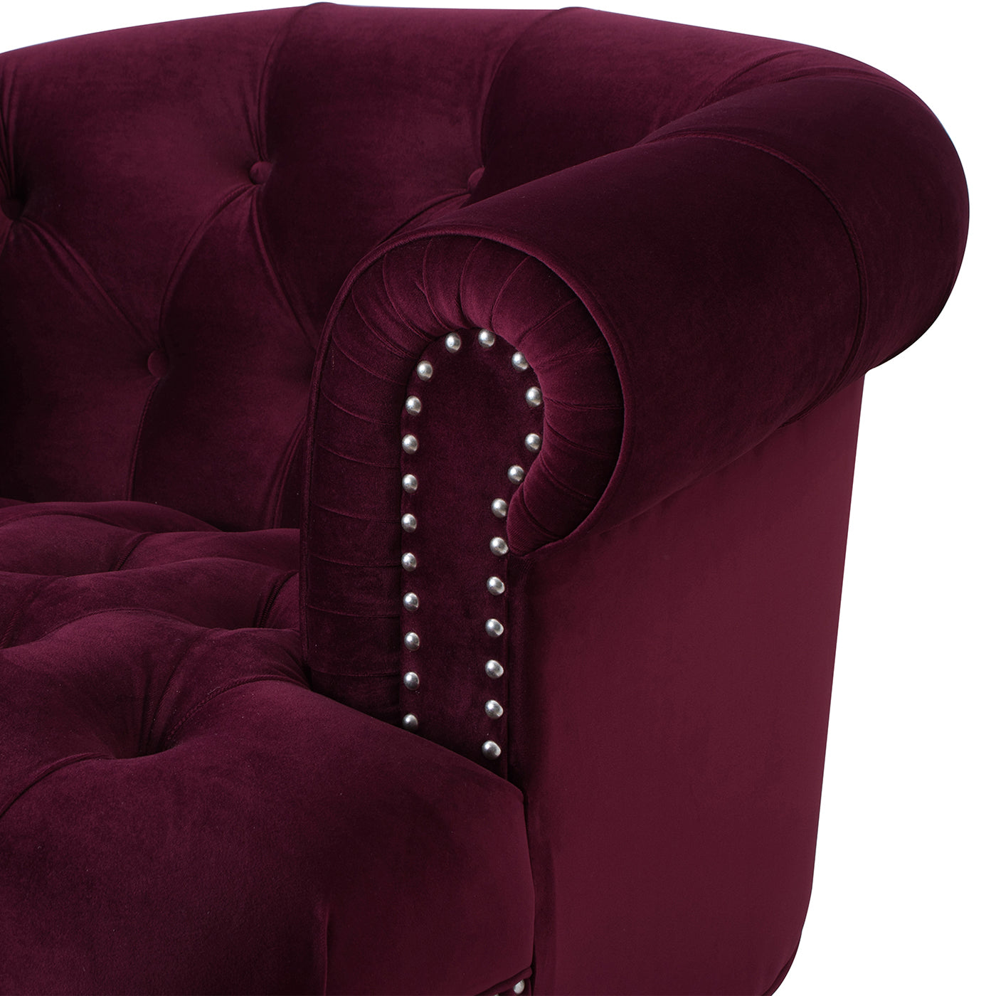 Deep red velvet armchair with tufted back and studded armrest detail