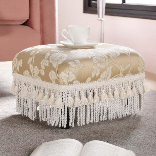 Ornate gold ottoman with floral pattern and fringe perfect for living room accent