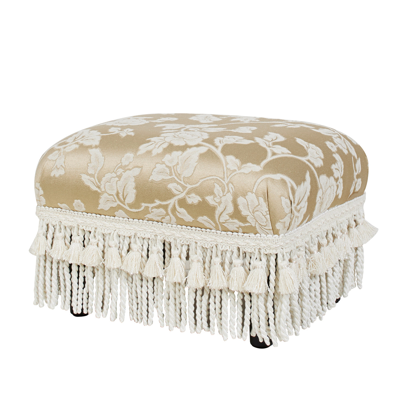 Upholstered ottoman with elegant damask floral pattern in gold and cream featuring ornate fringe trim