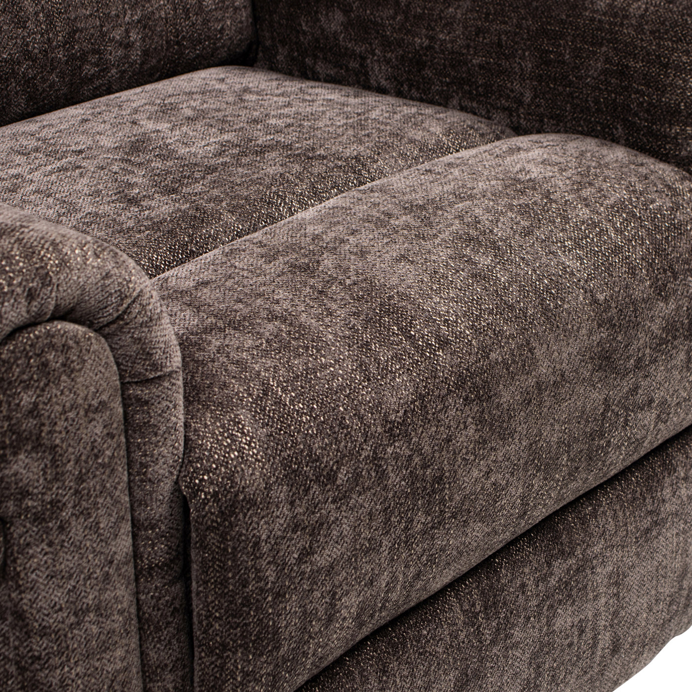 Closeup of a dark grey textured fabric armchair showing woven detail and soft sheen