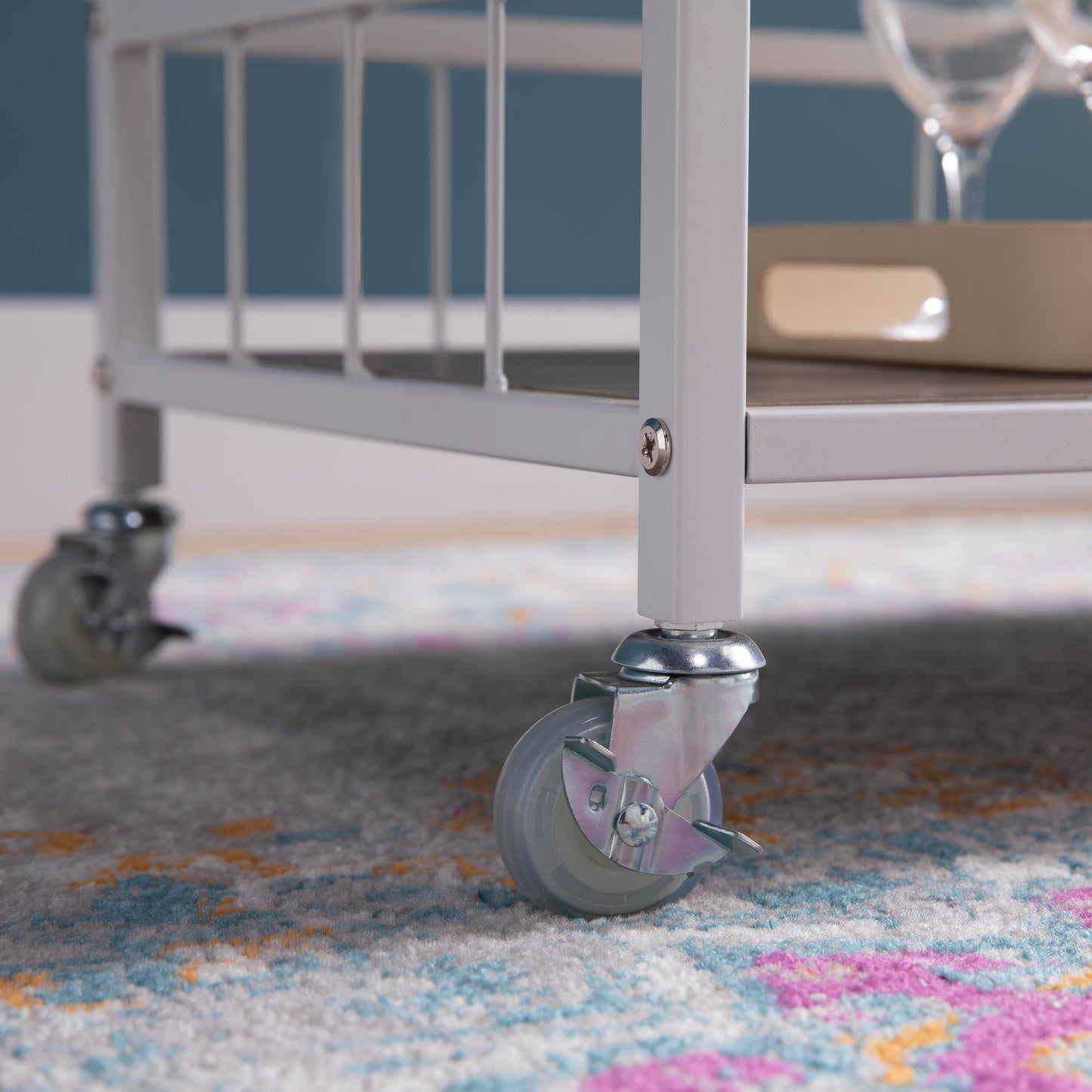 White metal bar cart with rolling casters
