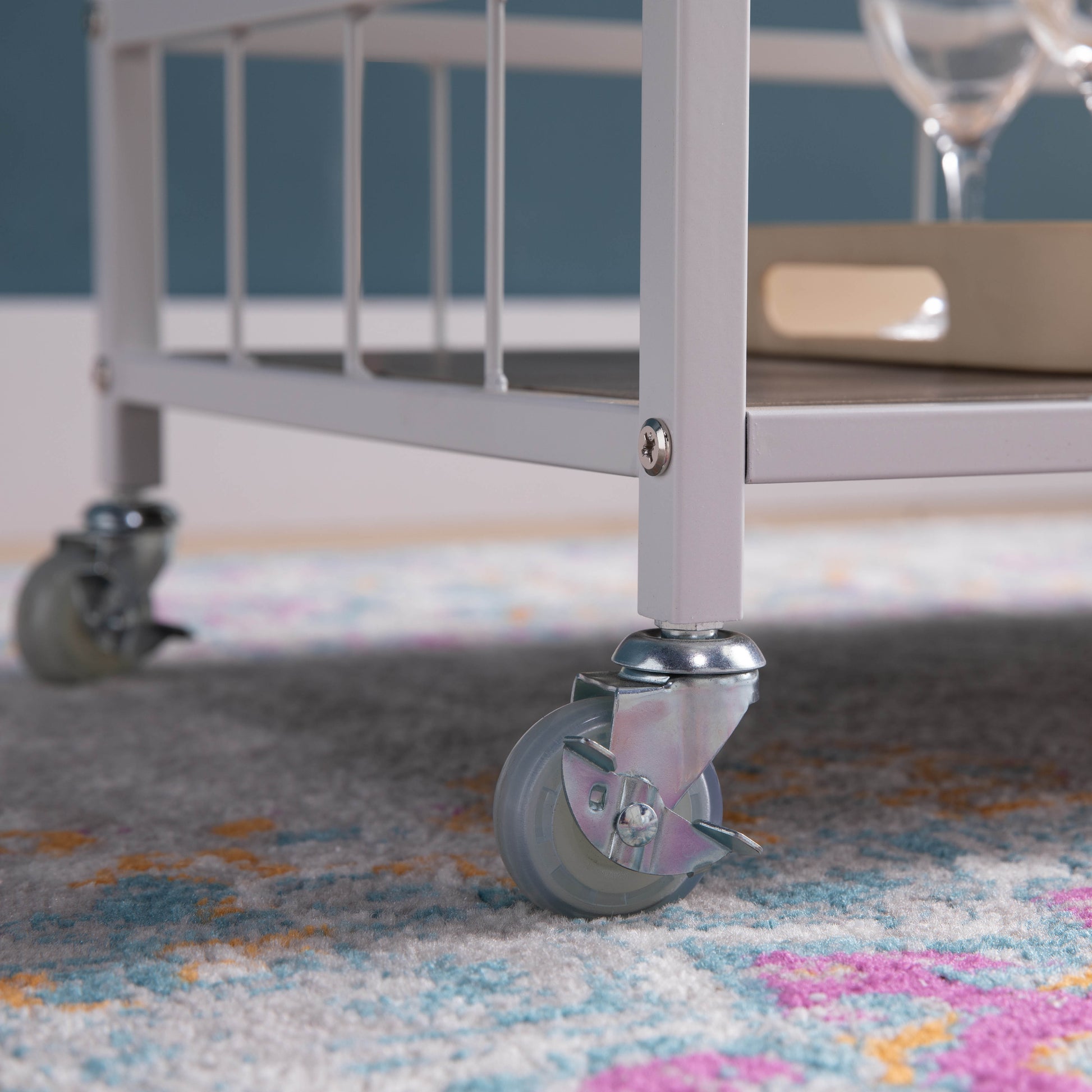 White metal bar cart with rolling casters