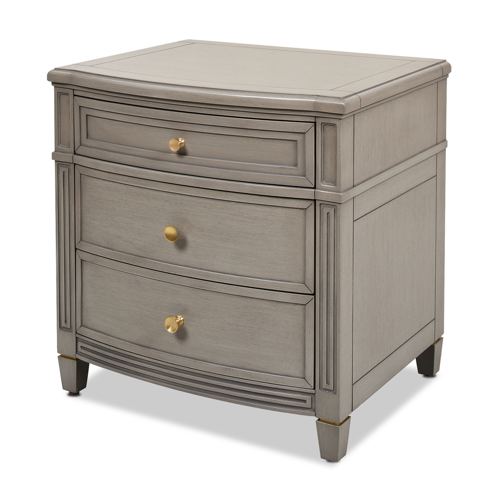 Gray curved threedrawer nightstand with brushed brass hardware and carved detailing