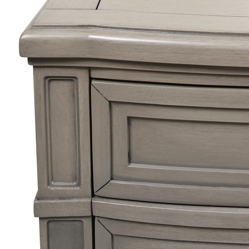 Gray wood dresser with paneled drawer fronts and decorative trim