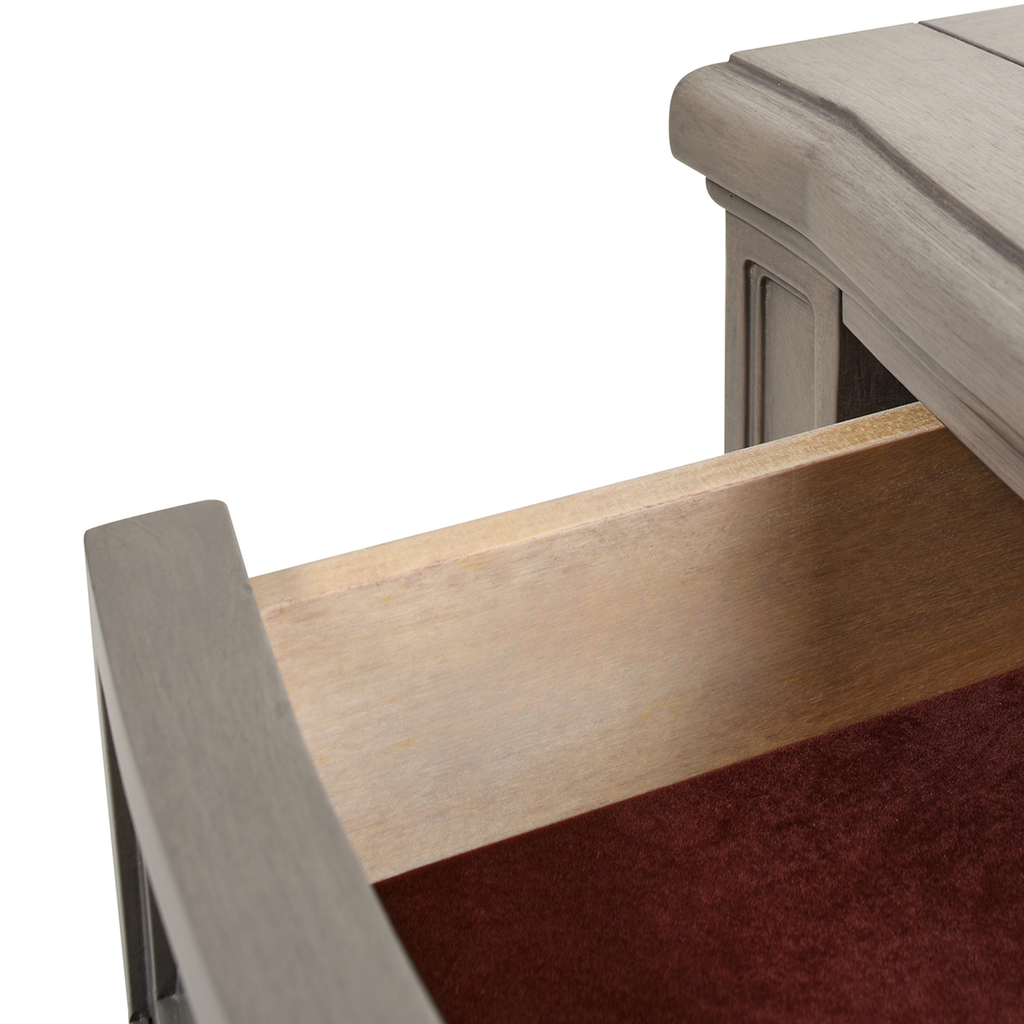 Close up of a grey wooden dresser drawer with velvet lining