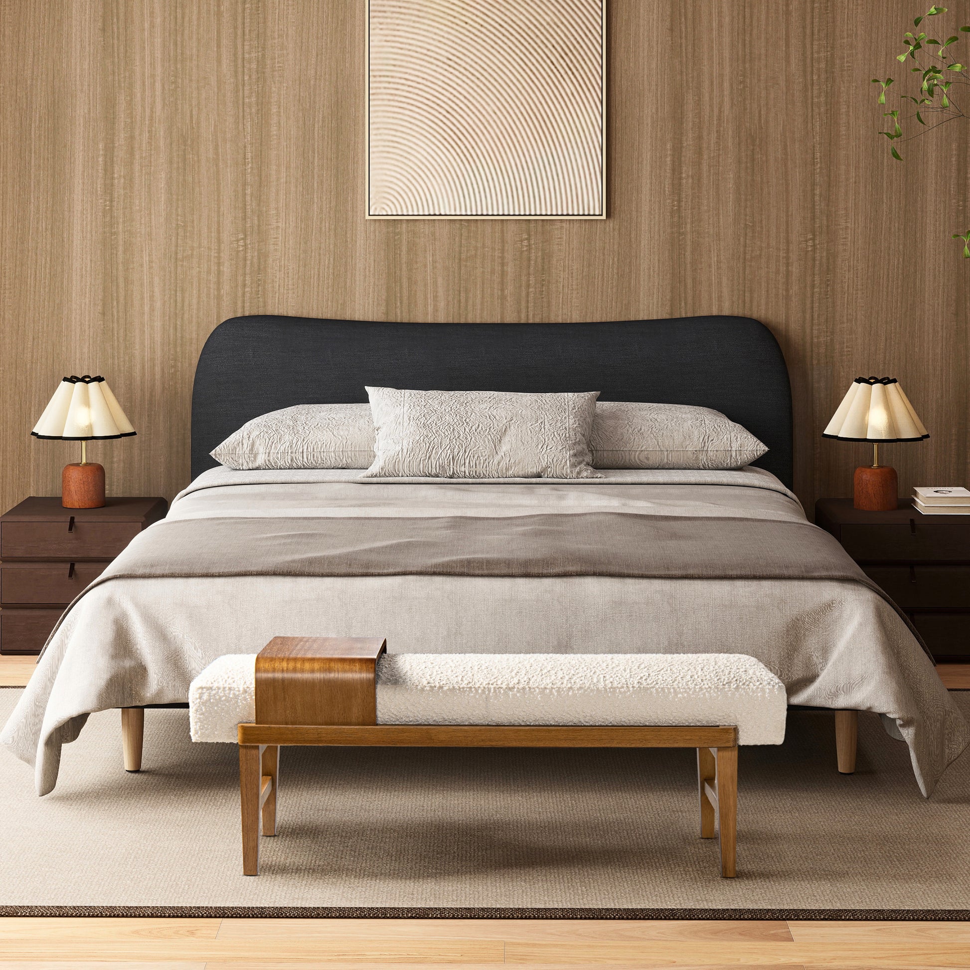 Dark charcoal upholstered headboard bed with textured pillows and throw blanket