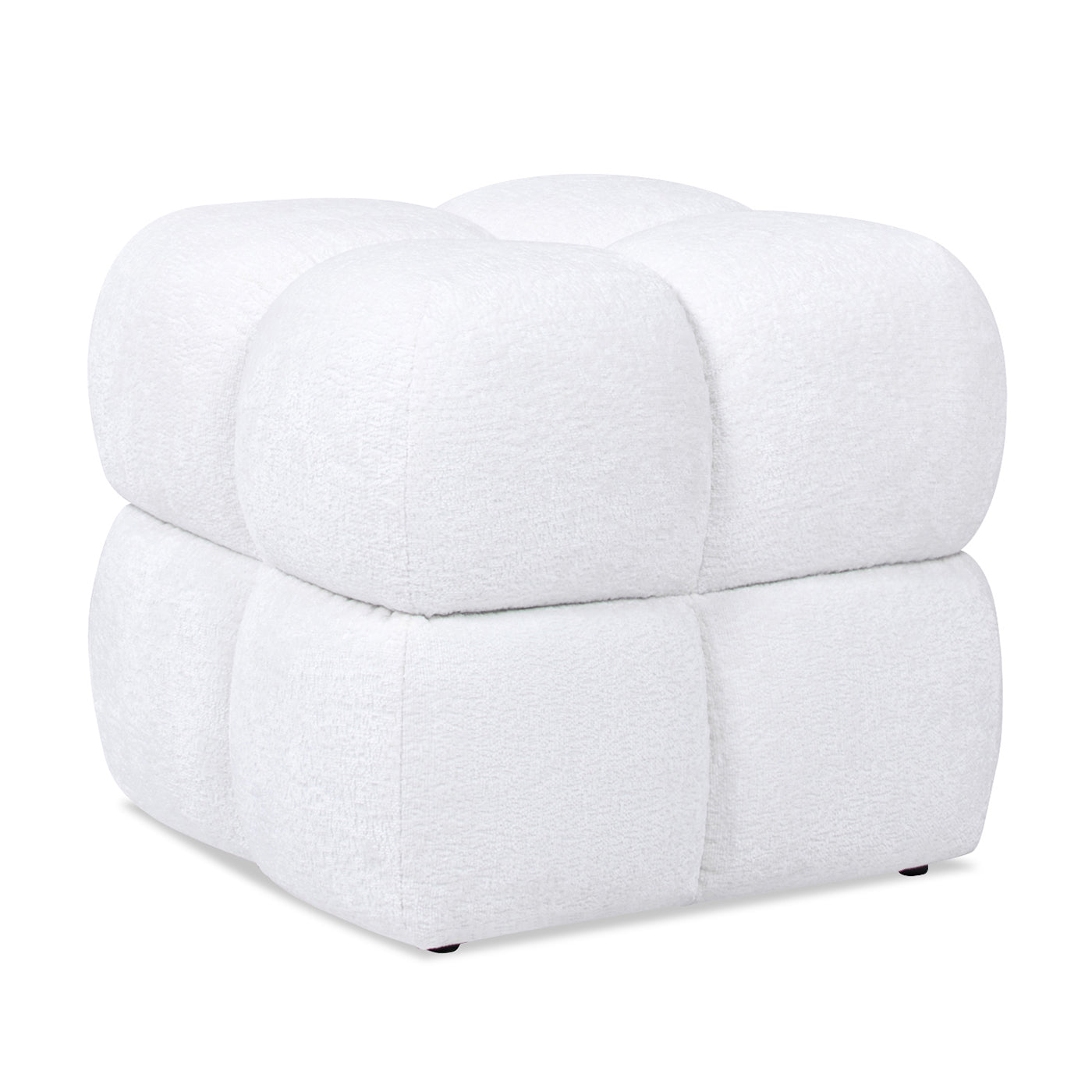 Plush white cube ottoman with rounded tufted segments a modern accent piece