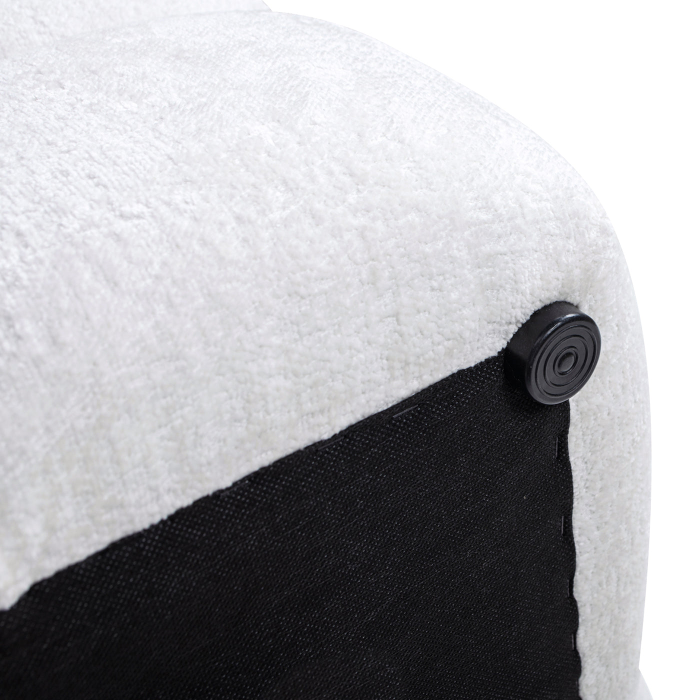 Closeup of a white textured fabric ottoman corner with a black foot protector