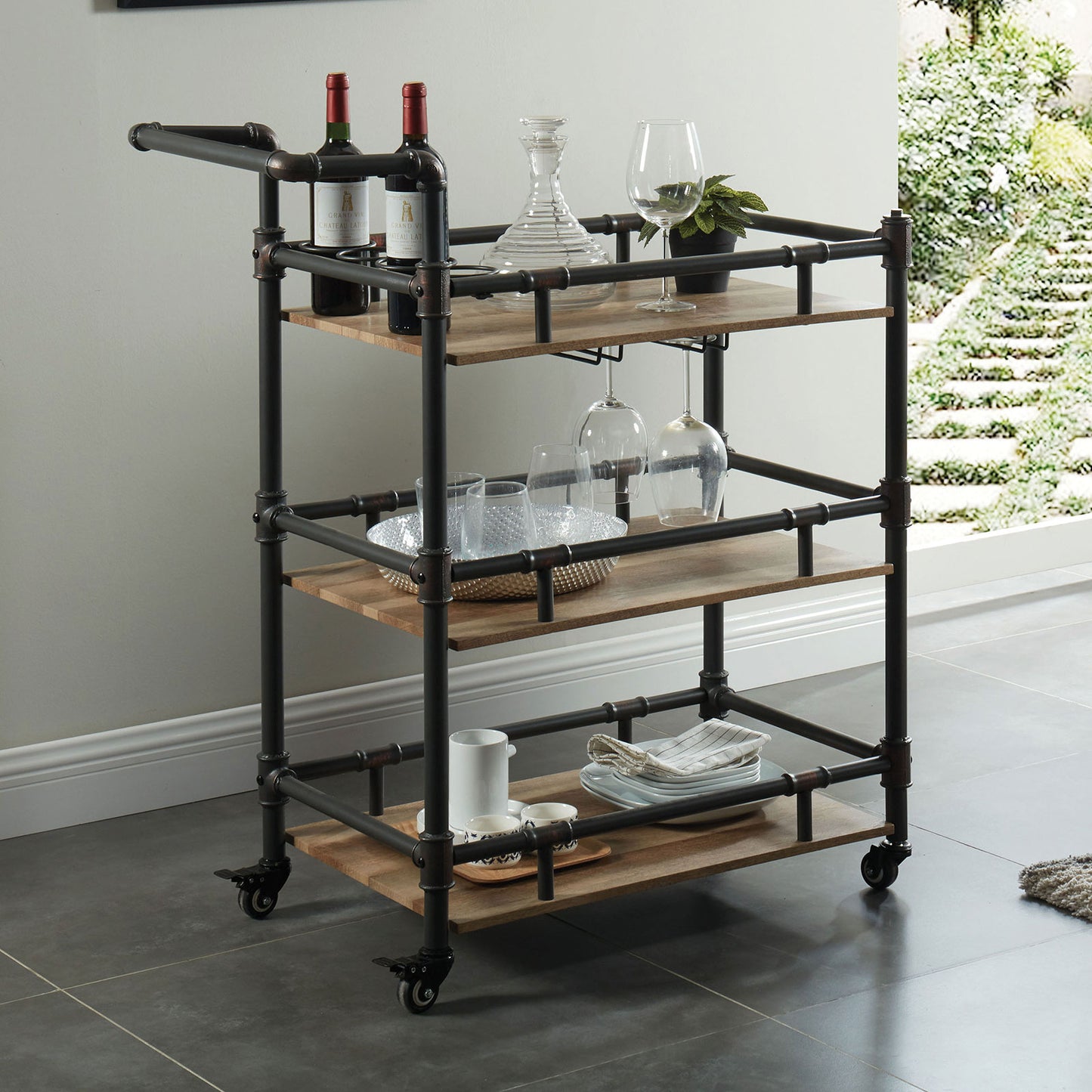 Industrial style bar cart with wood shelves and dark metal pipes