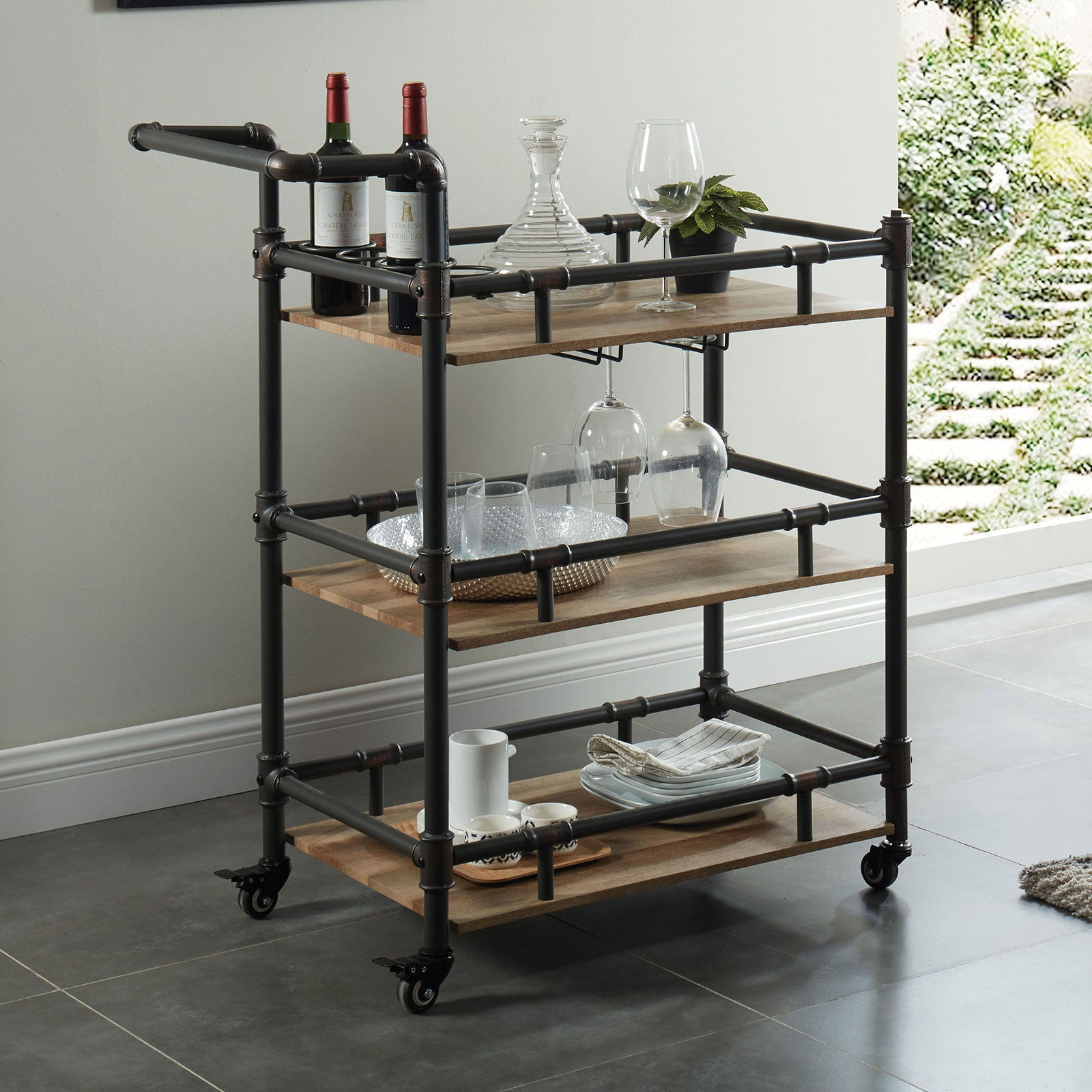 Industrial style bar cart with wood shelves and dark metal pipes