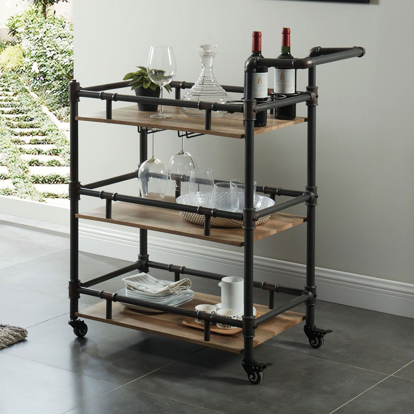 Rustic metal and wood bar cart with wine bottles and glasses