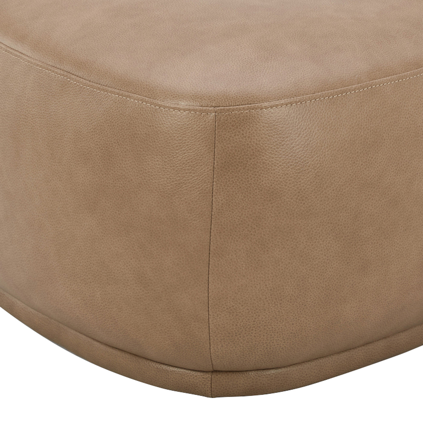 Closeup of a tan leather ottoman with stitched seams perfect for a modern living room