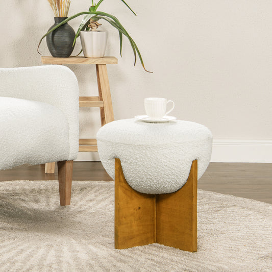 Plush white boucl ottoman with a curved wooden base and ribbed teacup on top