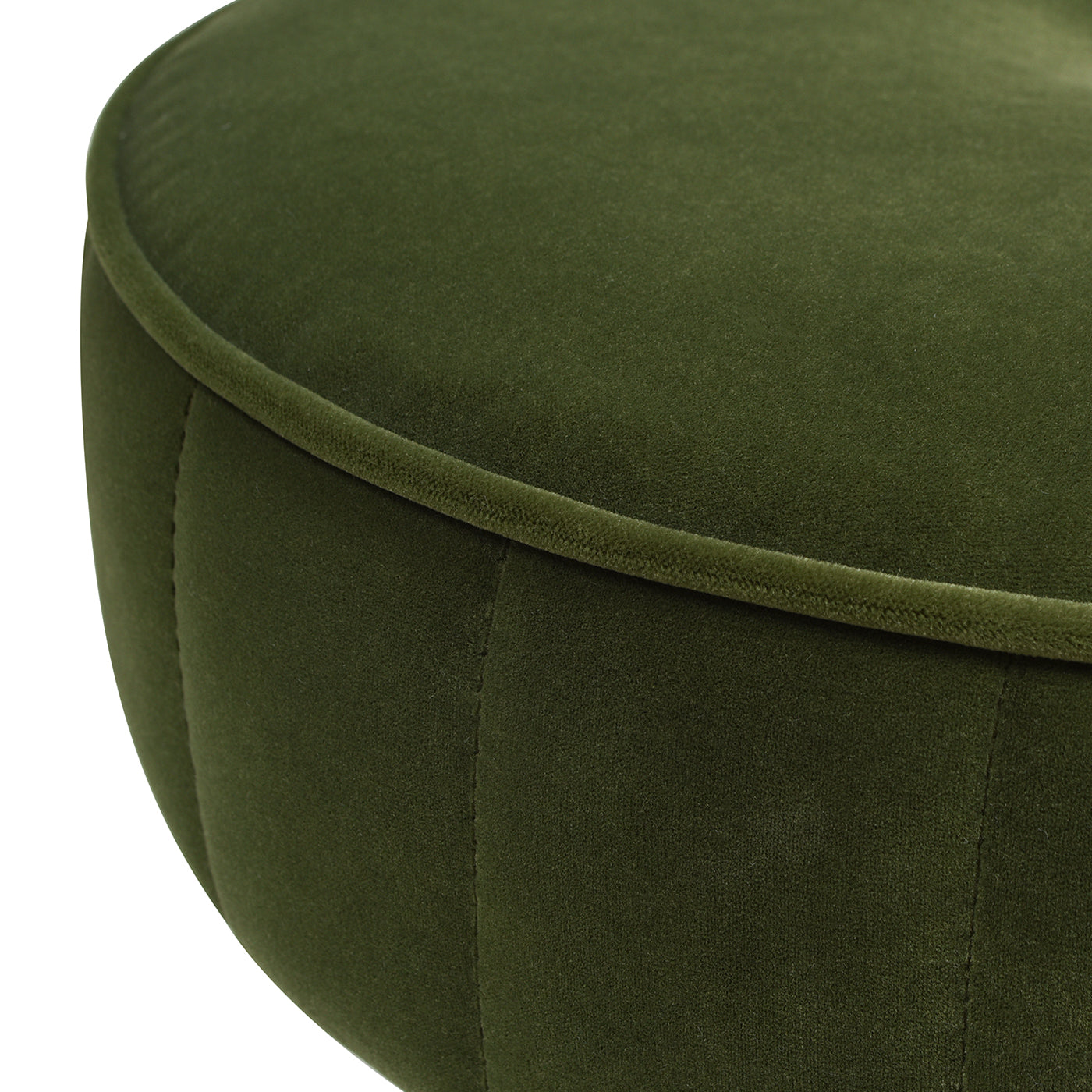 Close up of a round deep green velvet ottoman with piped edge detail