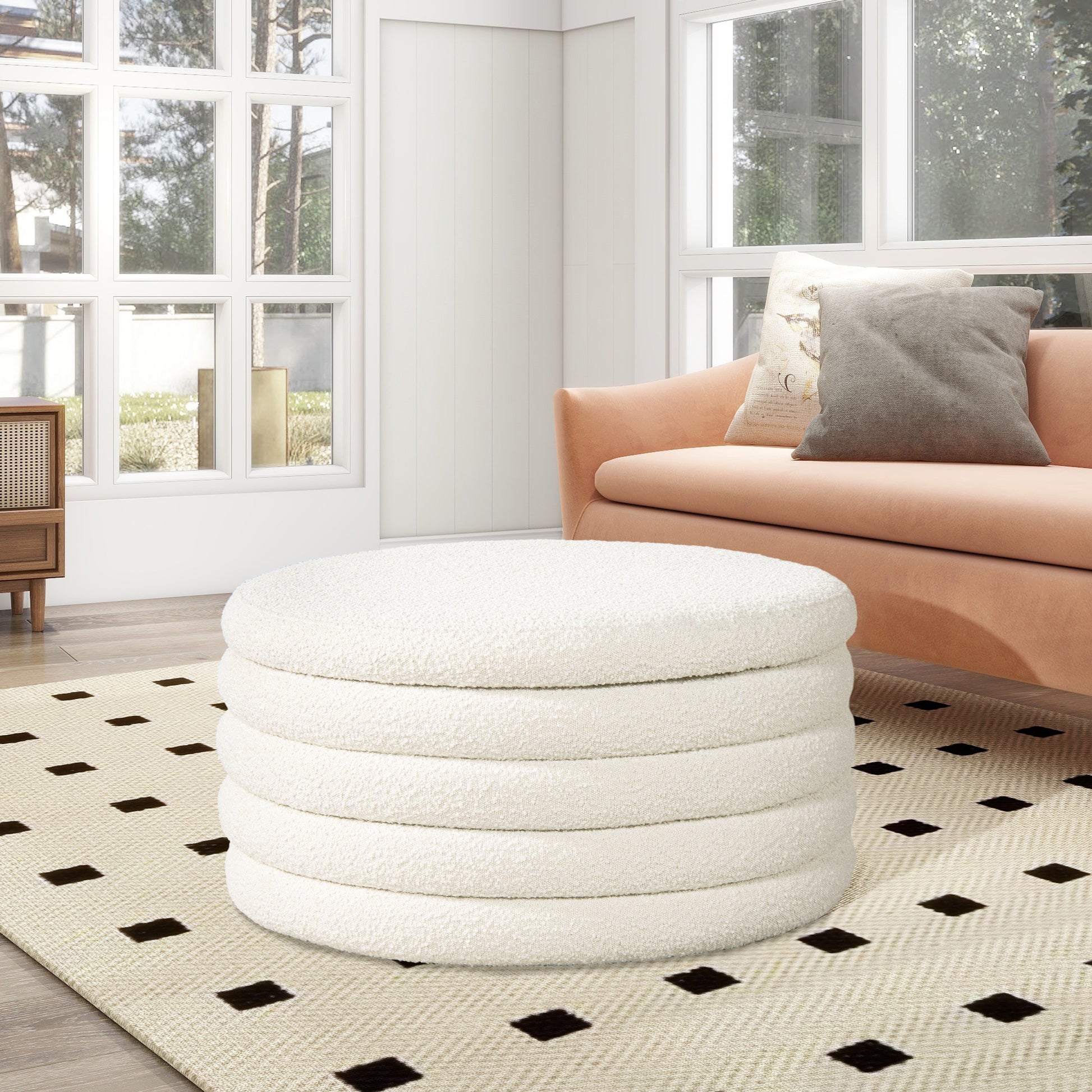 Plush white boucle round ottoman with segmented design adding texture and style to a living room