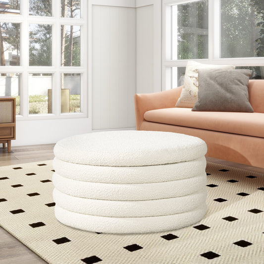 Plush white boucle round ottoman with segmented design adding texture and style to a living room