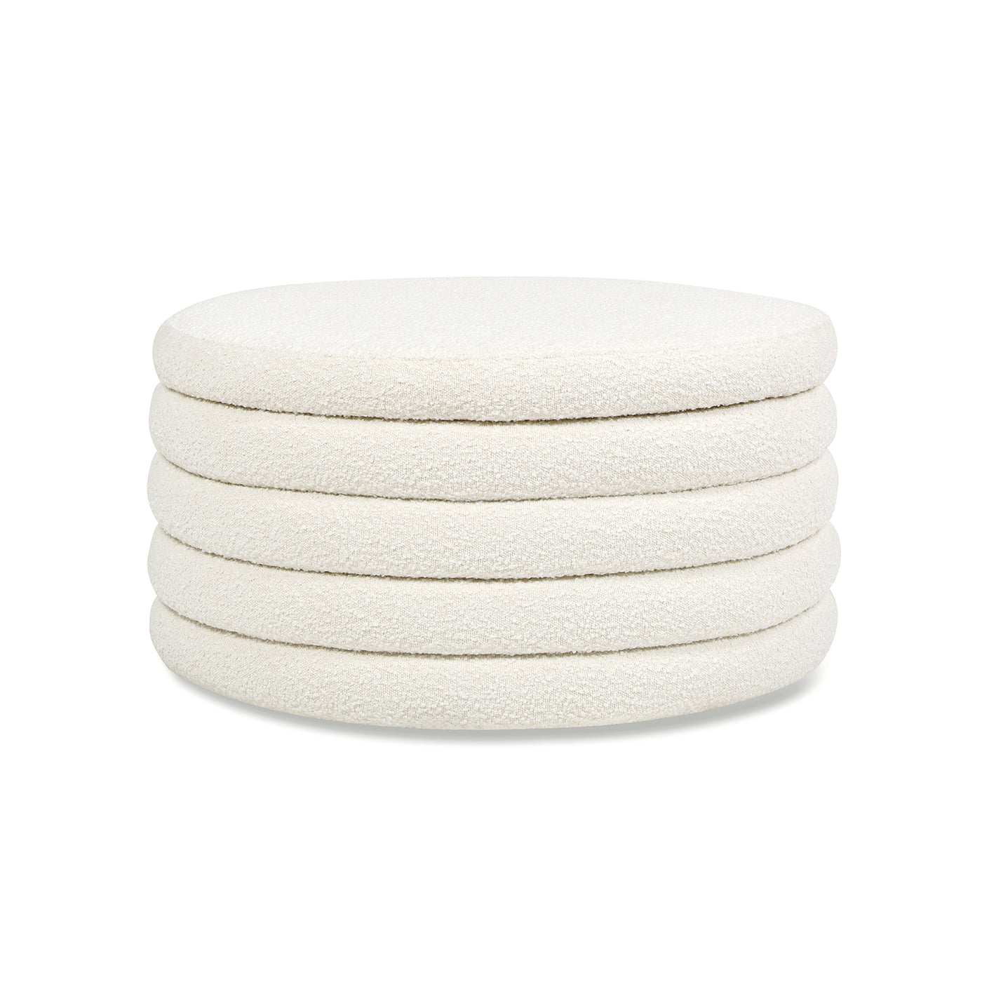 Circular ivory boucle ottoman with five layered cushions