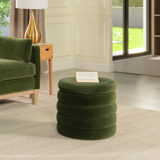 Plush green velvet ottoman with stacked cushion design and a book on top