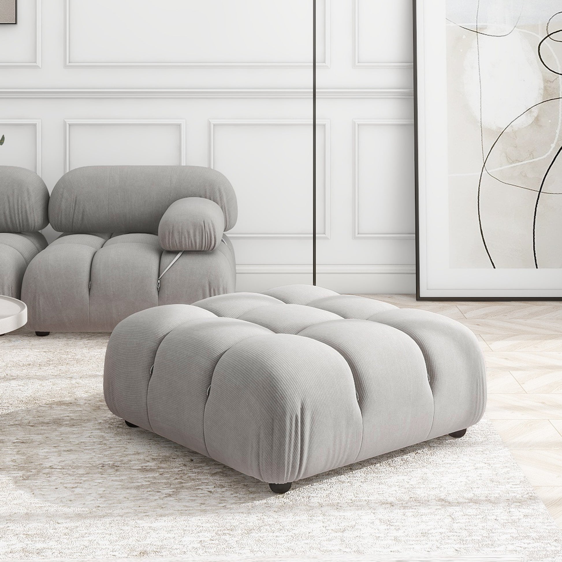 Gray tufted ottoman with corduroy texture perfect as a footrest or extra seat