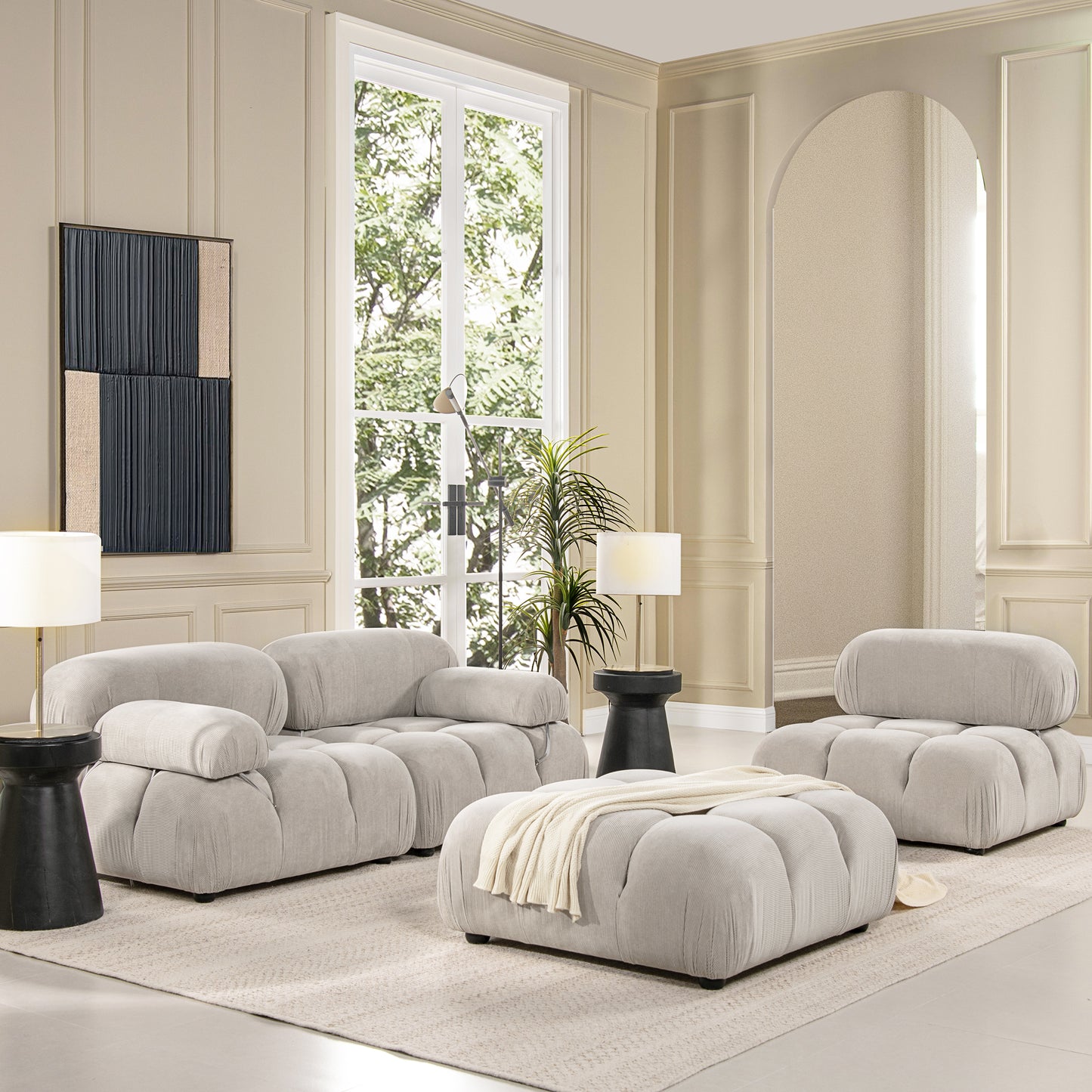 Plush light gray corduroy sectional sofa with an oversized ottoman perfect for modern living rooms