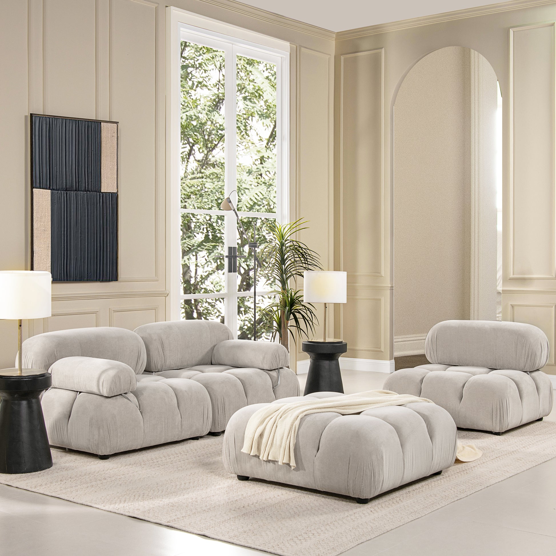 Plush light gray corduroy sectional sofa with an oversized ottoman perfect for modern living rooms