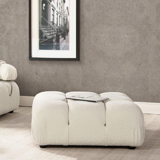 Plush boucle fabric ottoman in cream adds a soft texture to living spaces