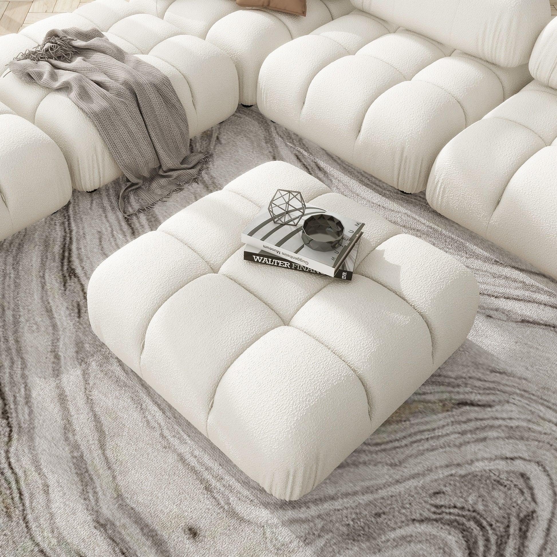 Cream boucle modular sofa with a matching tufted ottoman perfect for living room comfort
