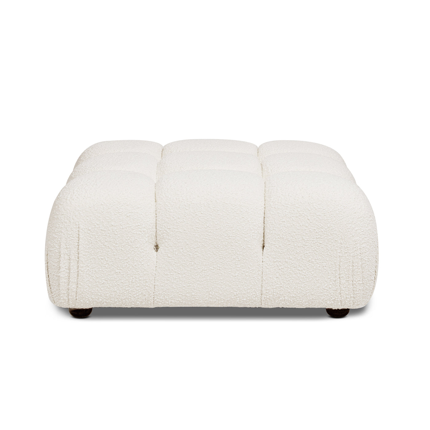 White boucle tufted ottoman with modern design and dark wood feet