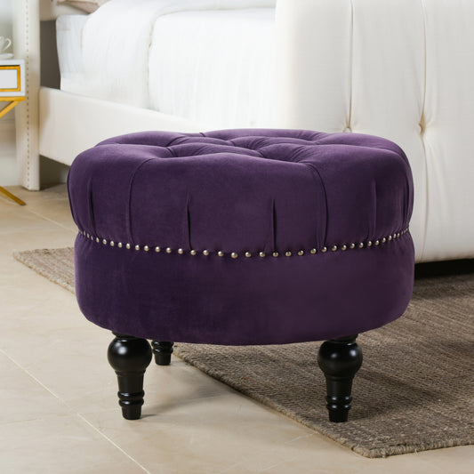Deep purple velvet tufted ottoman with nailhead trim and turned legs