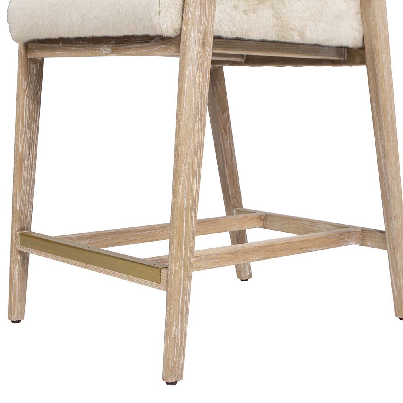 Cream faux fur counter stool with whitewashed wood legs and gold footrest