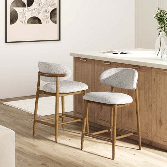 Two boucle fabric bar stools with wooden frames and curved backs perfect for a modern kitchen island