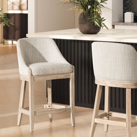 Light grey upholstered bar stool with a distressed wood frame perfect for a modern kitchen island