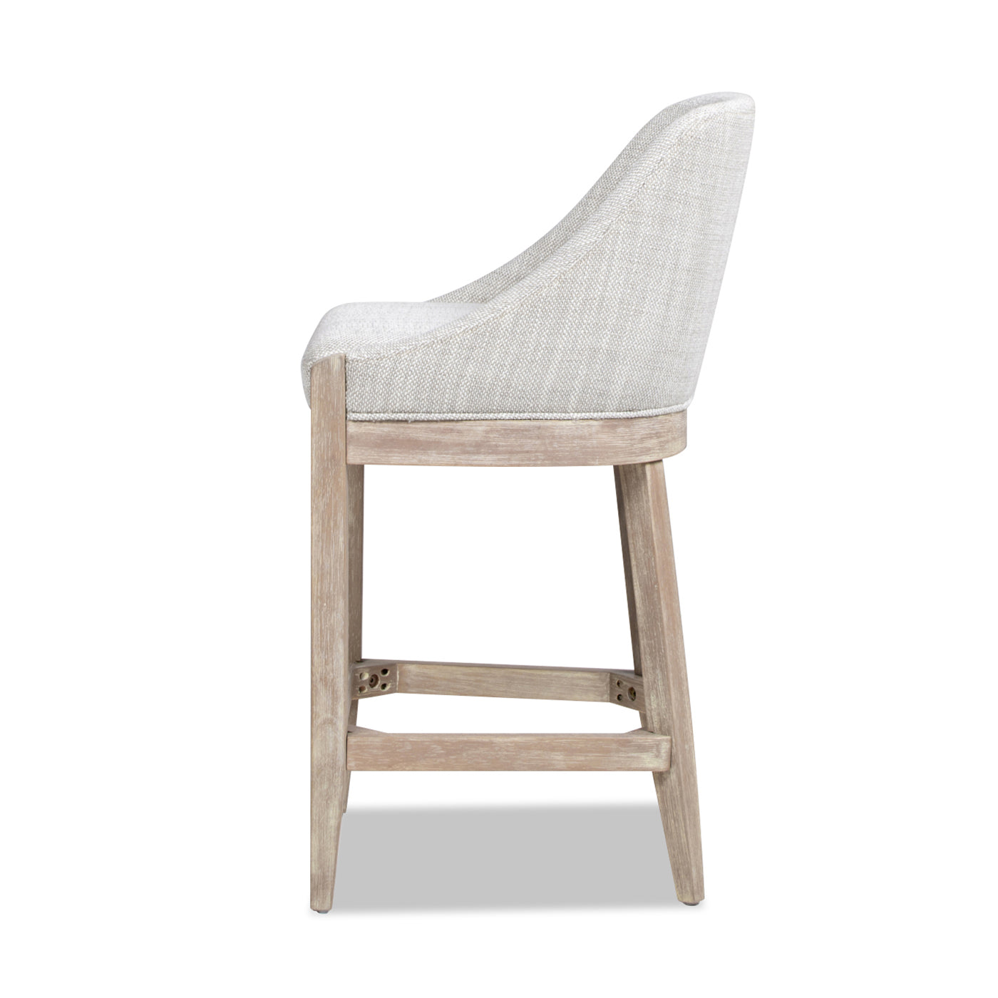 Side view of a light grey upholstered bar stool with a distressed wood frame
