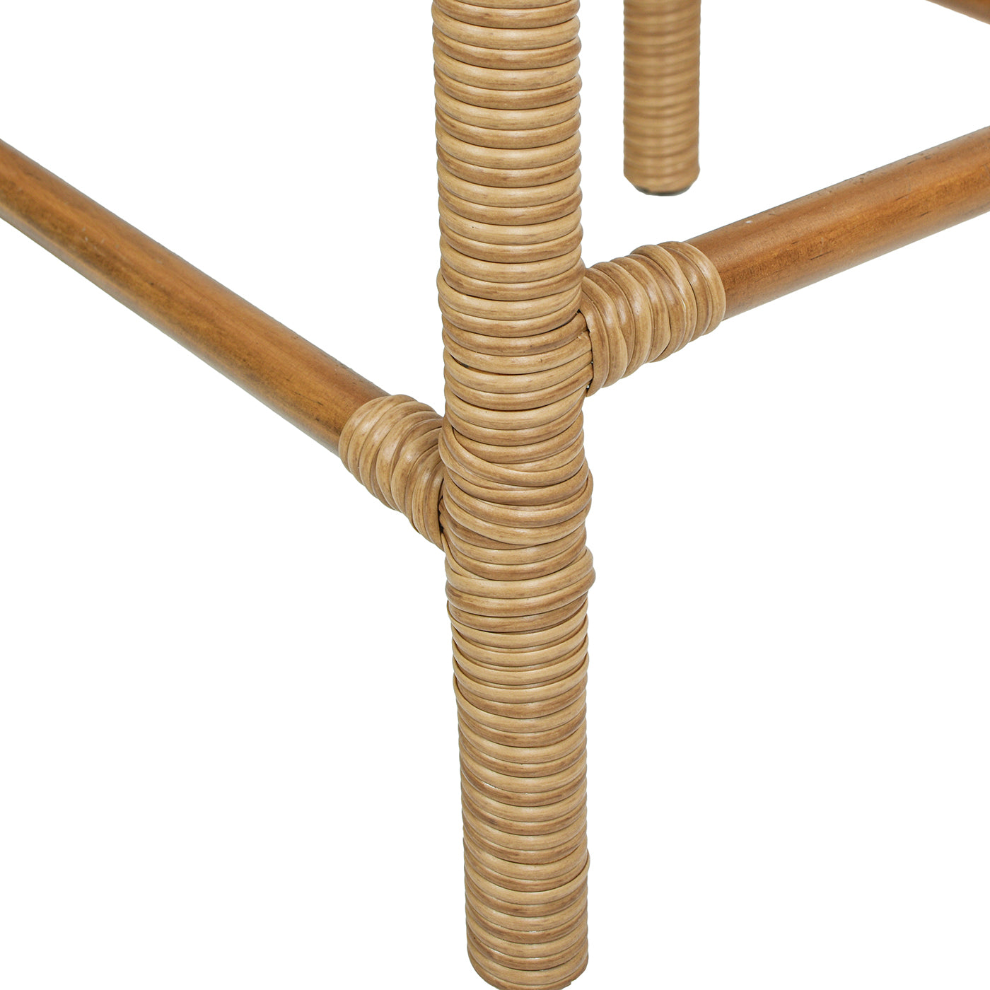 Closeup of natural rattan woven texture on wooden furniture legs highlighting craftsmanship