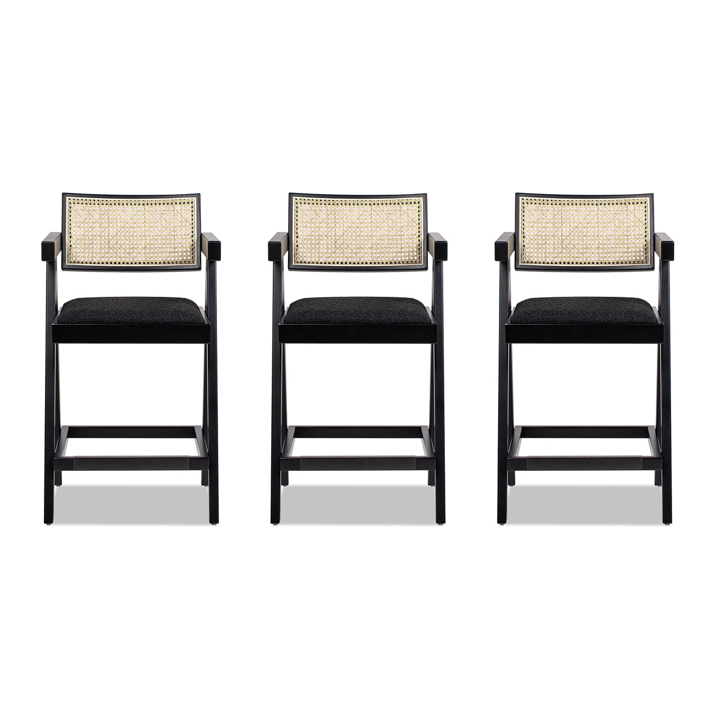 Three black wooden bar stools with cane backs and upholstered seats