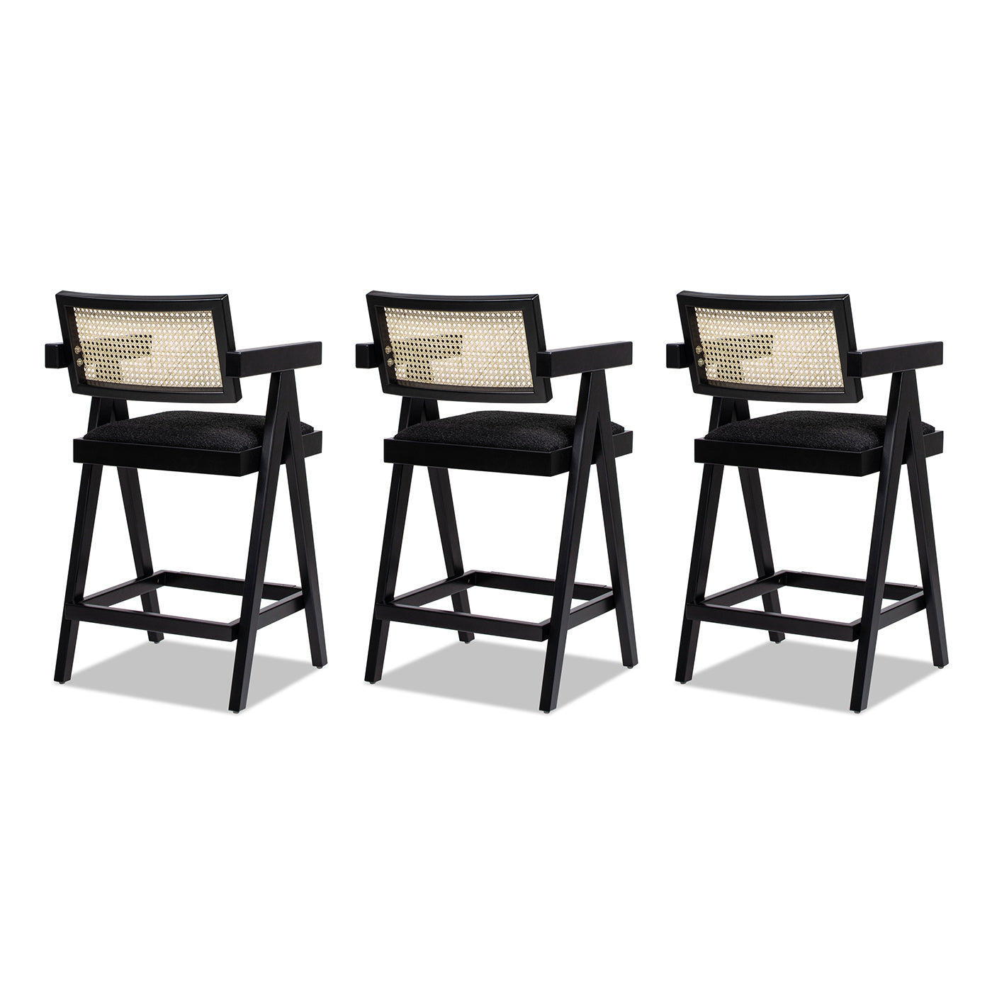 Three black wood and cane bar stools with upholstered seats